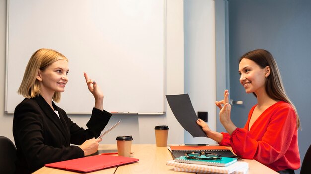 Side view of businesswomen using sign language