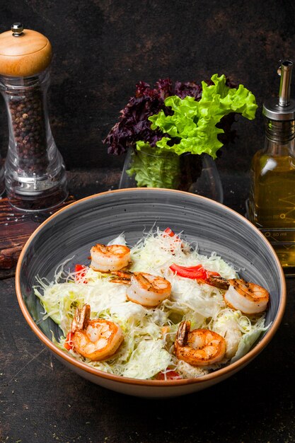 Side view caesar salad with fried shrimp