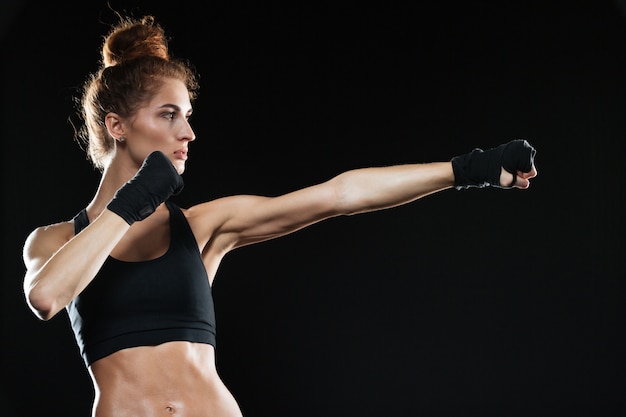 Side view of Calm female fighter practicing