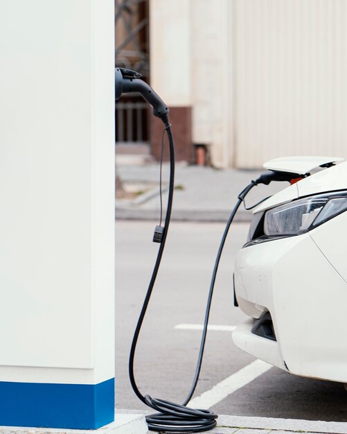 Side view of car being charged at electric vehicle charging station