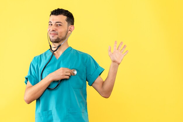 Side view cardiologist the cardiologist with phonendoscope is glad that he cured patients