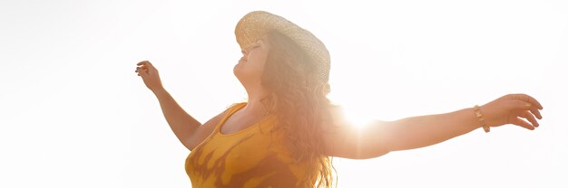 Side view of carefree woman outdoors in the sun