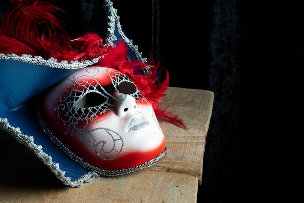 Side view of a carnival mask standing on a table