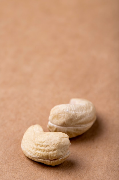 Side view of cashews isolated on old paper texture background