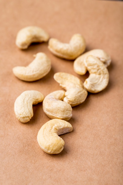 Side view of cashews on old paper texture background