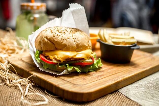 Side view cheese sandwich and french fries on the board