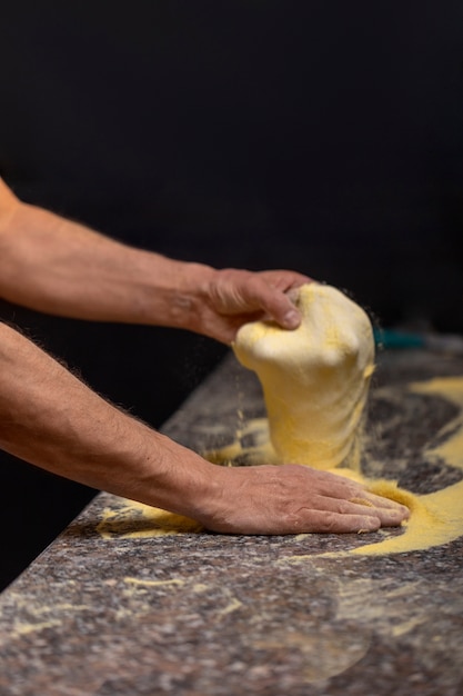 Side view chef preparing pizza