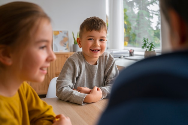 Free photo side view children playing memory game