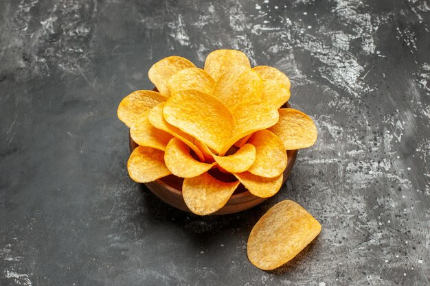 Side view of chips in bowl on dark grey table