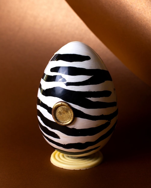 Free photo side view chocolate egg in zebra color