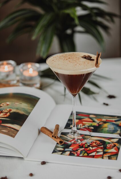 Side view of chocolate martini with spices and cinnamon in glass on the table