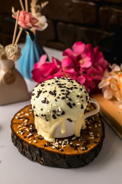 Side view of chocolate pudding cake with chocolate sprinkles on a wooden board