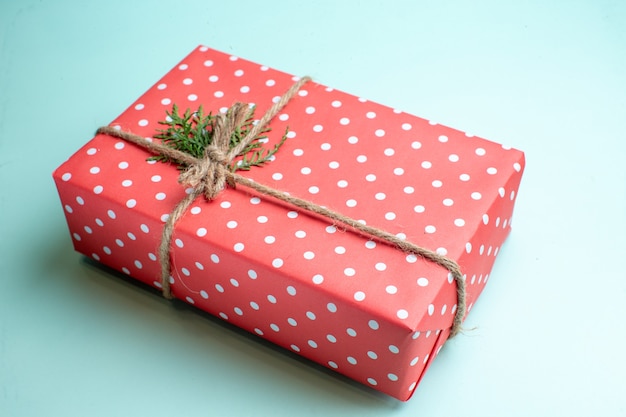 Free photo side view of christmas background with gift box on pastel green background