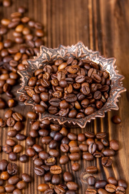 Side view coffee beans in an iron vase