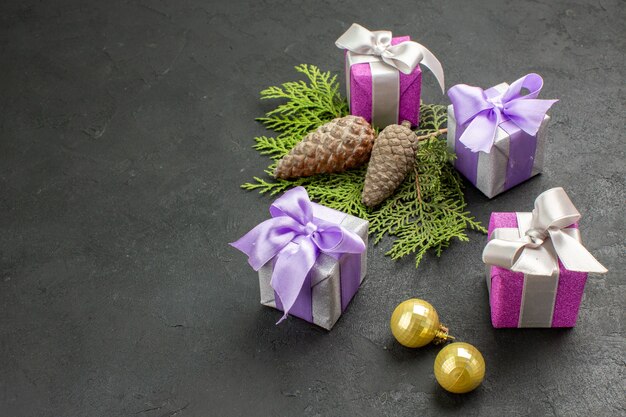 Side view of colorful gifts and decoration accessories on dark background