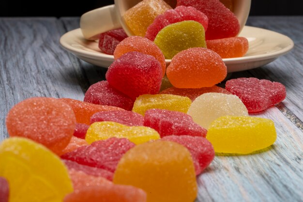 Side view of colorful tasty marmalade candies on rustic