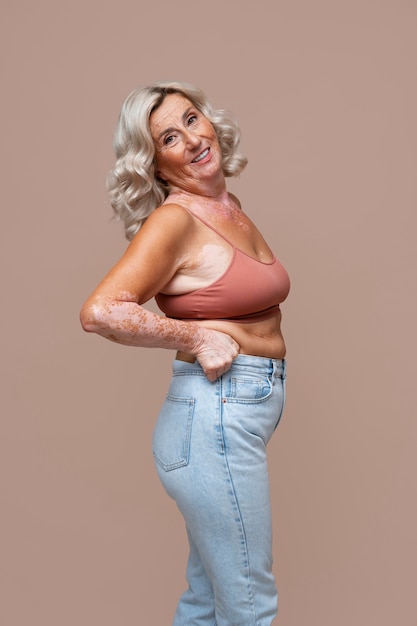 Side view confident old woman posing in studio