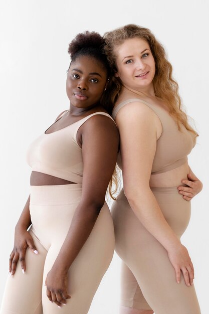 Side view of confident women posing while wearing a body shaper