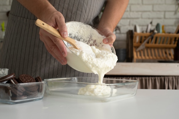 Side view cook pouring cream