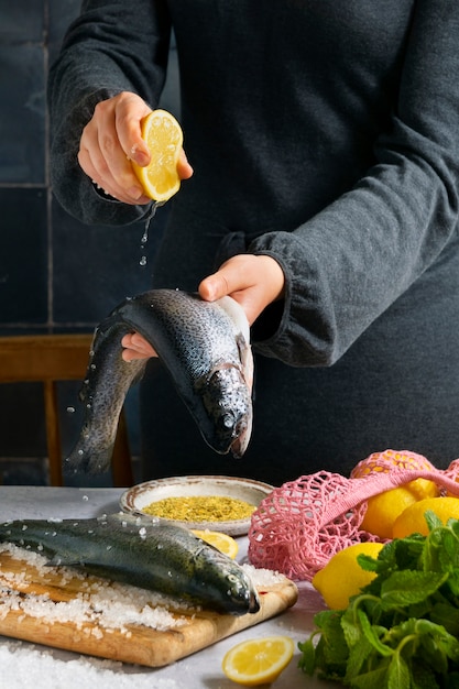 Side view cook preparing raw trout