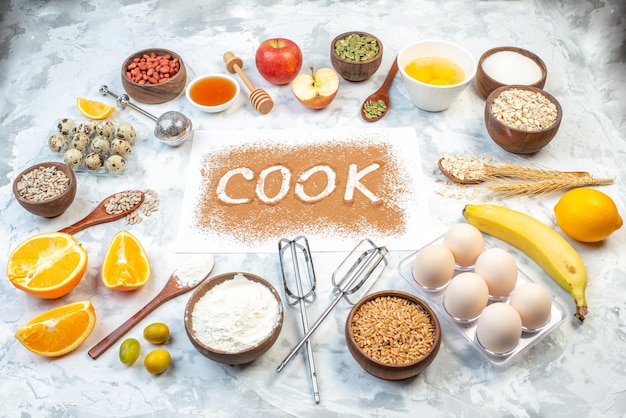 Free photo side view of cook writing with coffee flour in a bow cracked eggs fresh fruits raw oatmeal on ice background