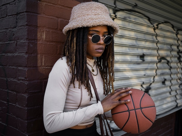 Side view cool woman holding ball