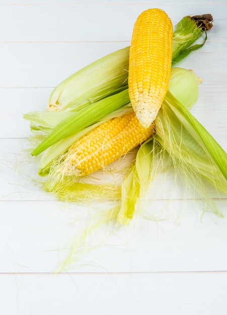 Side view of corn cob on wooden surface with copy space