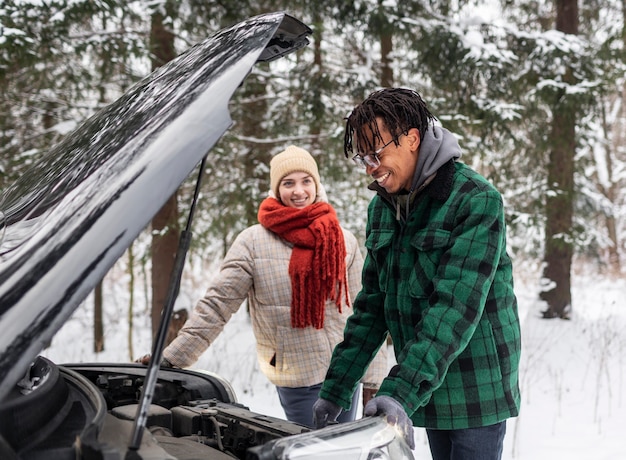 Side view couple checking car