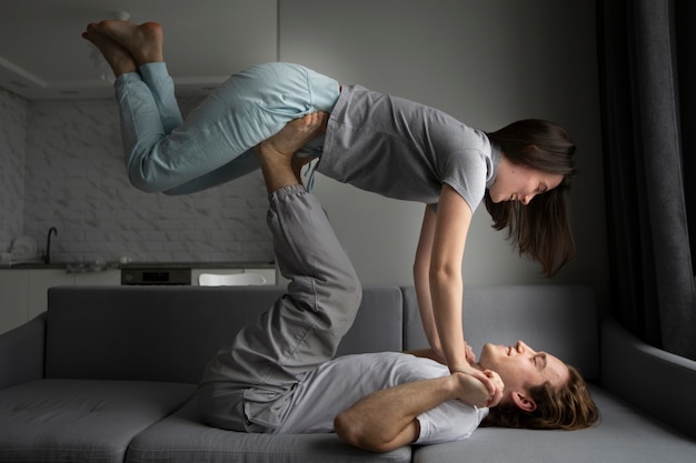 Side view of couple exercising poses