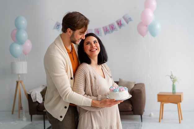 Free photo side view couple at gender reveal party