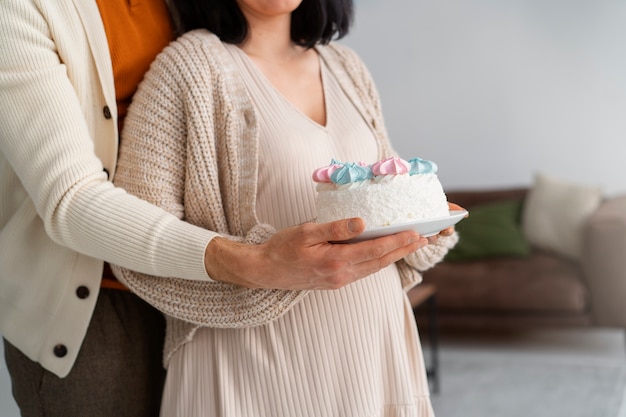 Free photo side view couple at gender reveal party