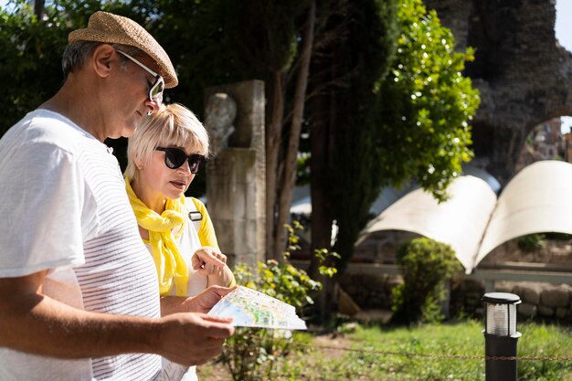 Side view couple holding map