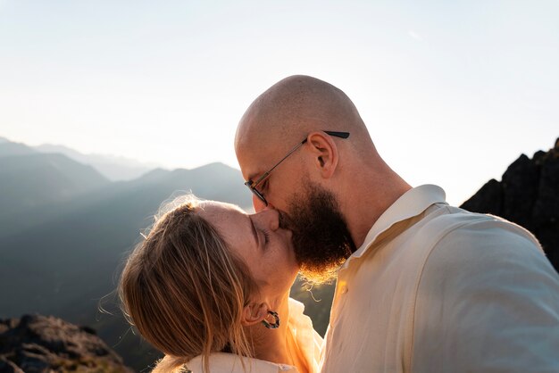 Side view couple kissing on mountain