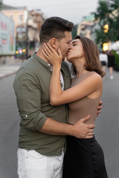 Side view couple kissing outdoors