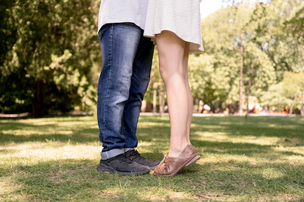 自然の中でロマンチックなカップルの足の側面図