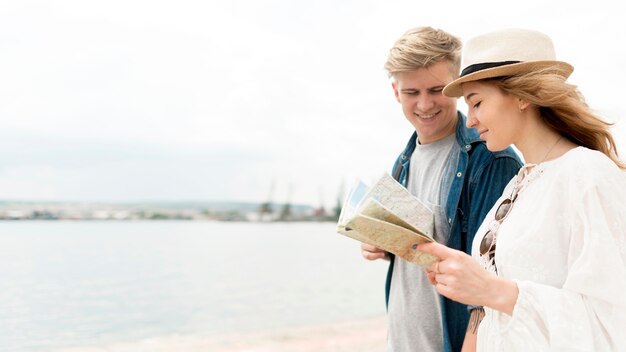 Side view couple looking at map