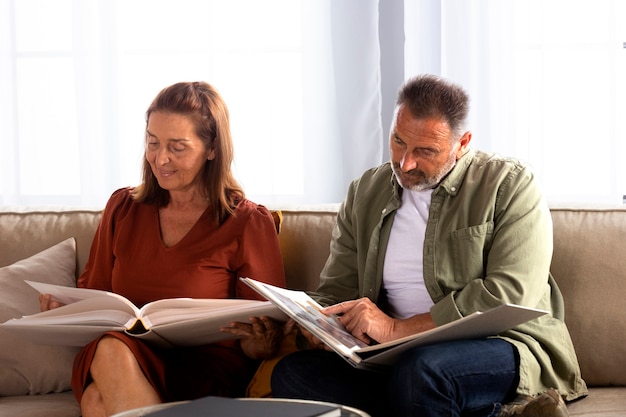 Side view couple looking at picture albums