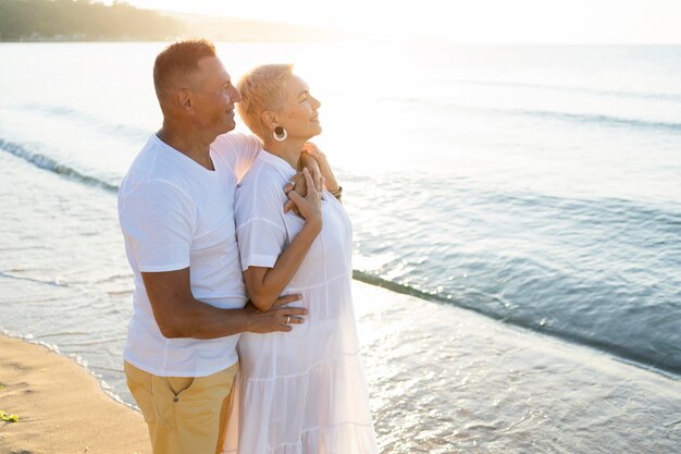 Side view couple looking at sea