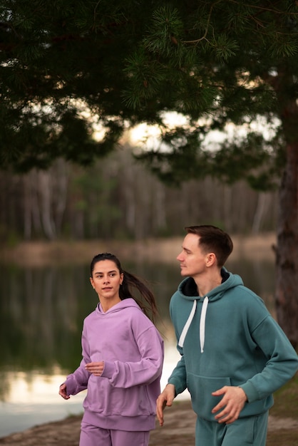 Side view couple running together