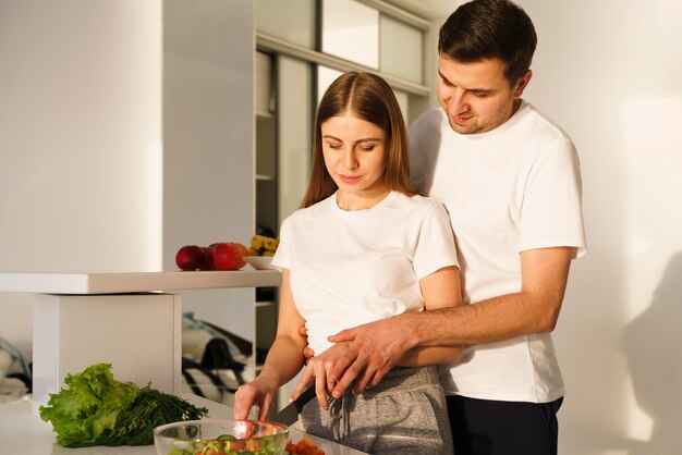 Side view couple seasoning salad