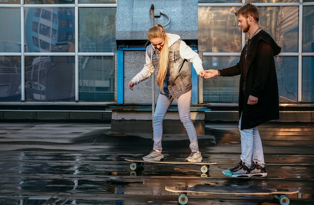 Side view of couple skateboarding together