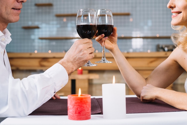 Side view of couple toasting during dinner