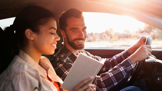 Side view couple traveling by car