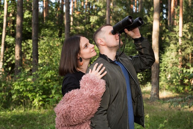 Side view couple with binoculars