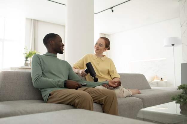 Side view couple with massage gun