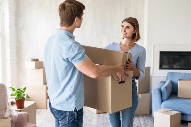 Side view of couple with moving out boxes