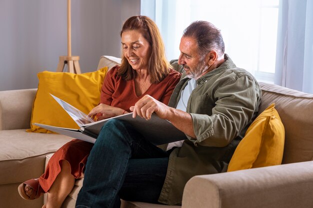 Side view couple with picture albums