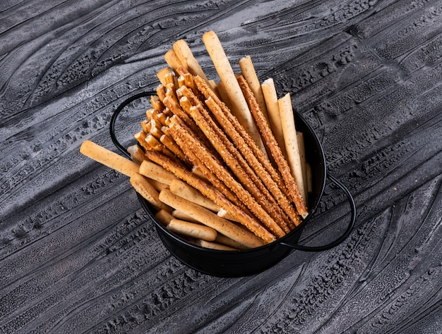 Side view of crackers in black pan on dark  horizontal