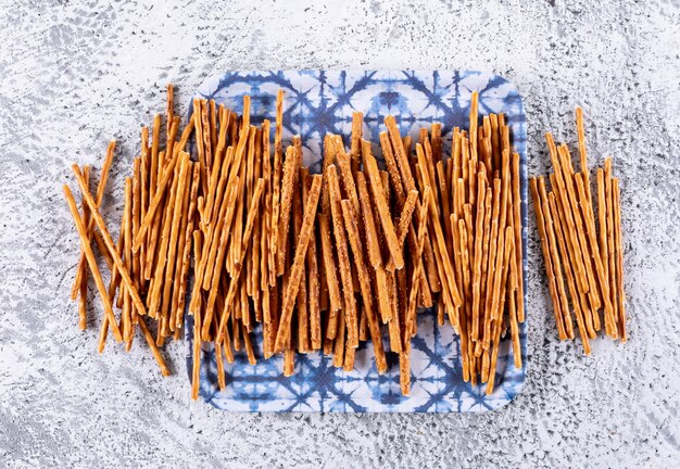 Side view crackers on blue cloth on white stone horizontal