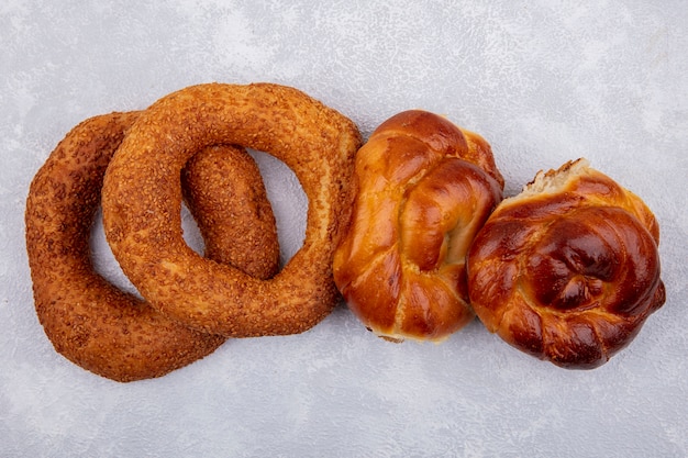 Side view of crispy and delicious sesame turkish bagels with buns on a white background